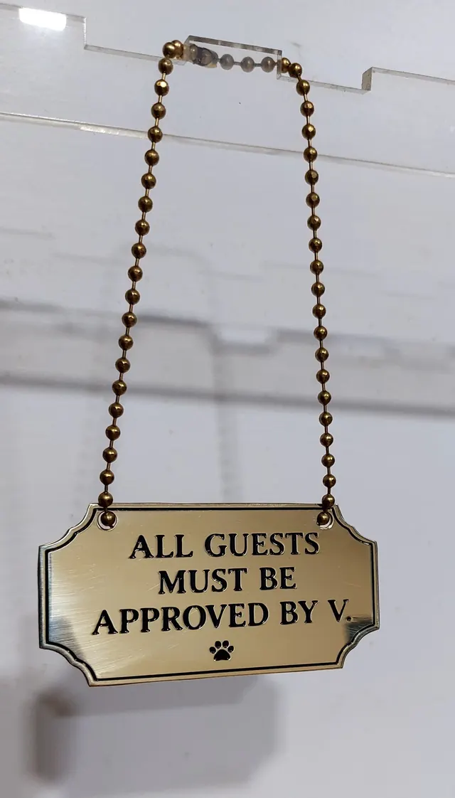 Brass hanging sign on a ball chain