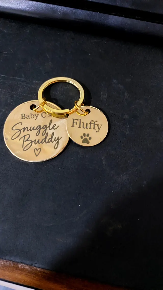 Close-up of two engraved brass tags