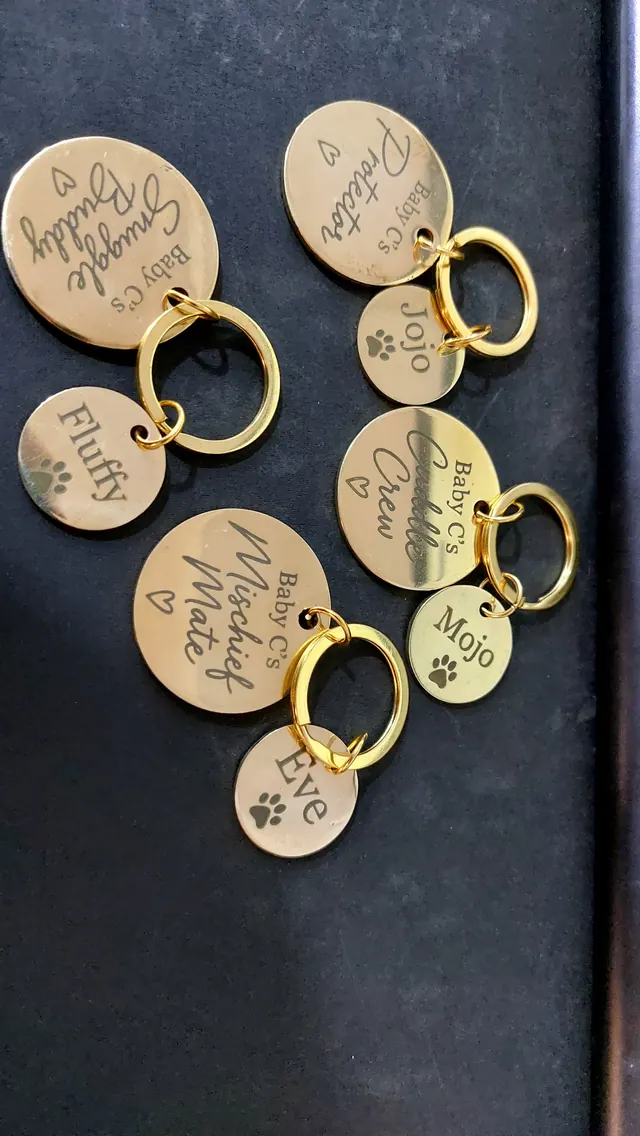Batch of engraved round brass pet tags