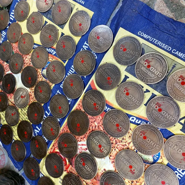 A batch of Operation Sindoor coins laid out for checking