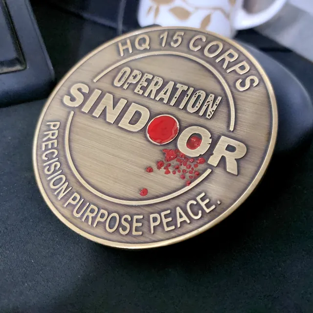 Close-up of the Operation Sindoor coin relief and red accent